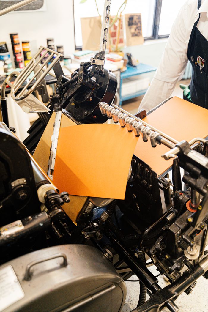 Crafting Captivating Headlines: Your awesome post title goes here Close-up of a vintage printing press with orange paper, highlighting industrial craftsmanship.