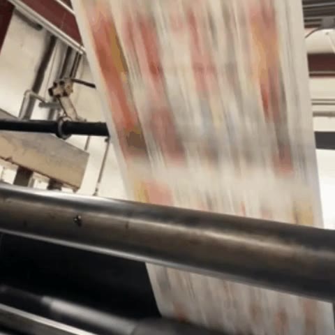 Web offset press printing CMYK on a paper roll